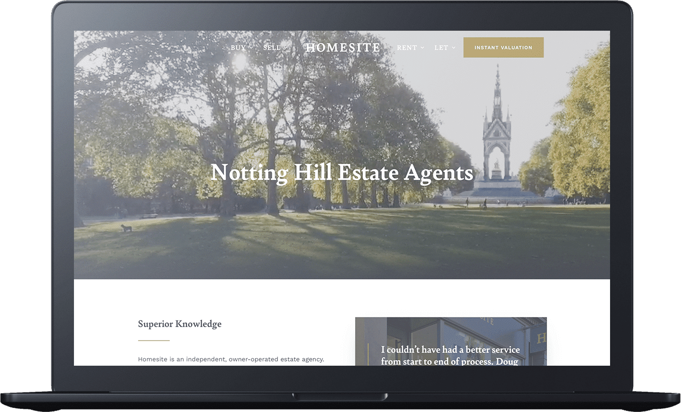 Laptop screen displaying a real estate website with an image of a park and church in the background, showing 
