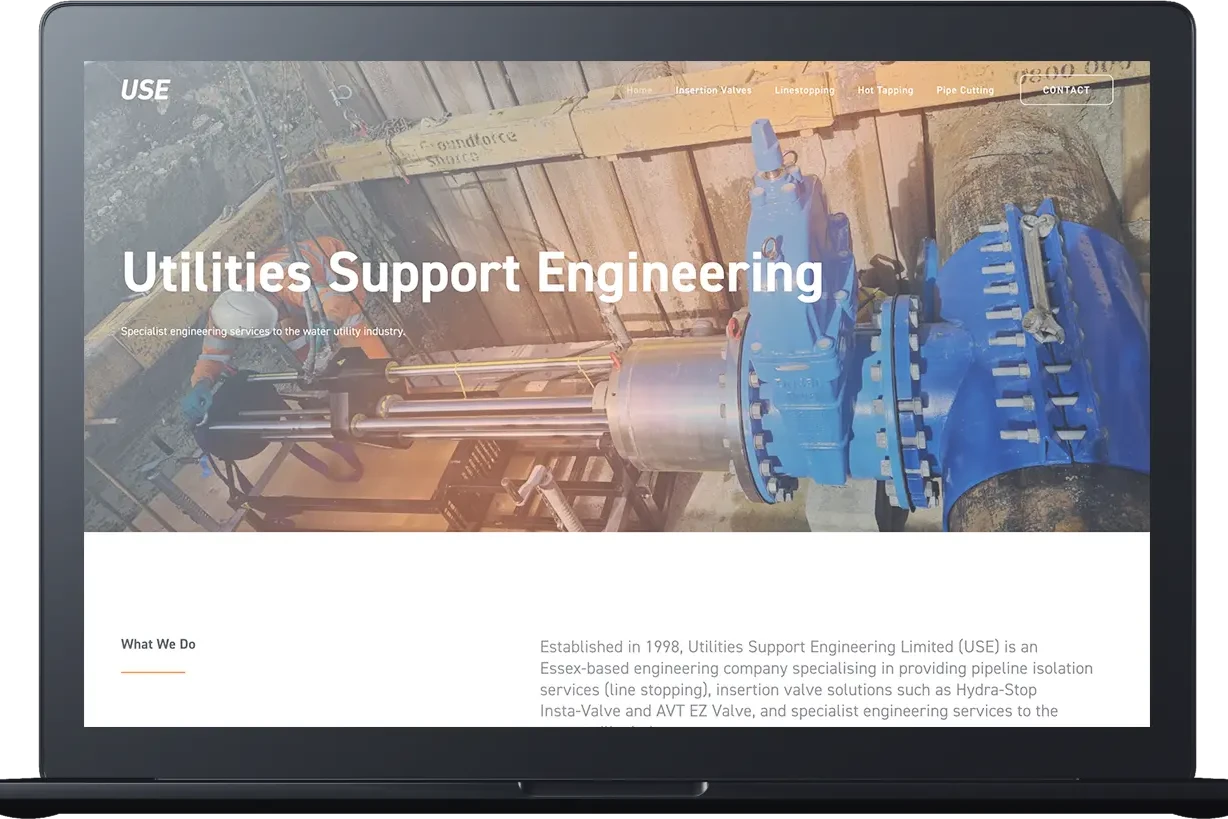 A computer screen displays the Utilities Support Engineering website, featuring industrial pipeline equipment and a brief company description.