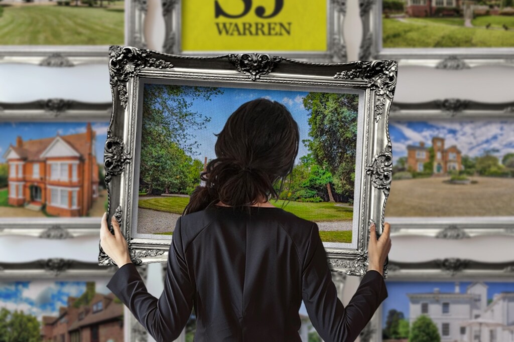 A woman holding a picture frame, ready to make new memories—brought to you by SJ Warren Estate Agents.